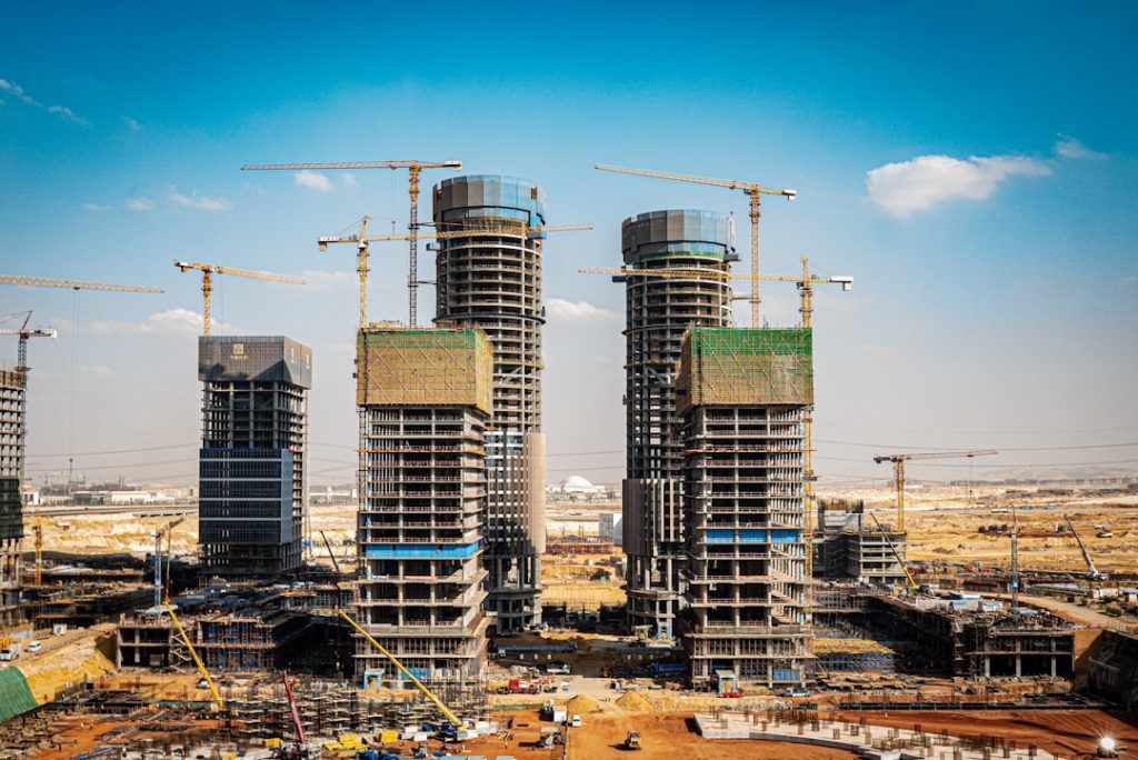a-group-of-tall-buildings-under-construction-qyzo7tdsvqs a-group-of-tall-buildings-under-construction-qyzo7tdsvqs